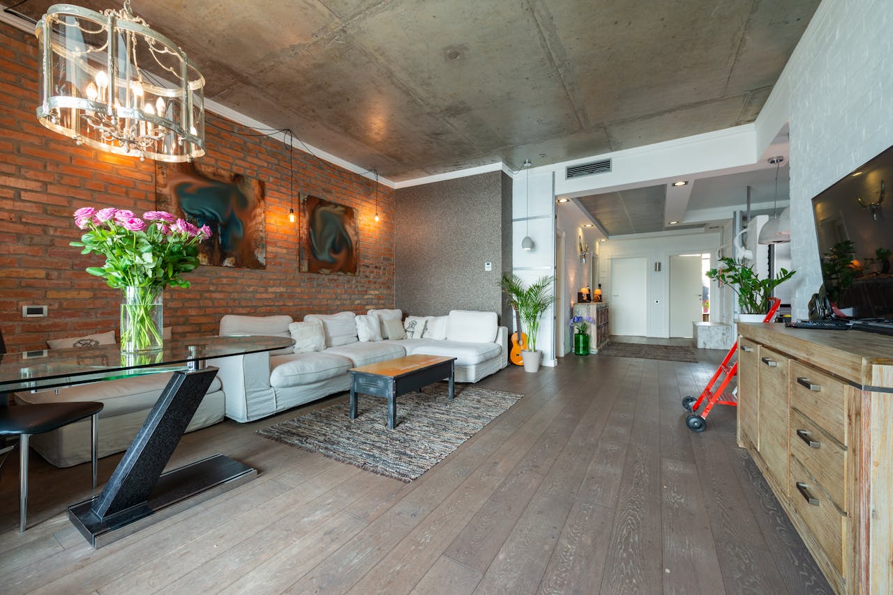 hero-img Spacious modern loft living room with elegant décor and industrial design elements.