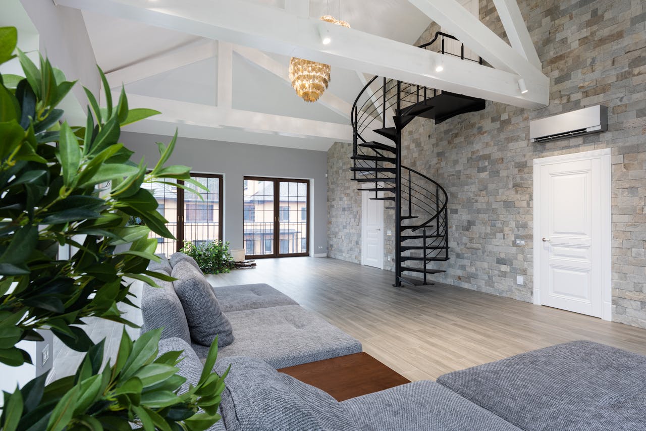 services-02 Interior of large prestige flat with soft gray sofa and verdant plants in daytime